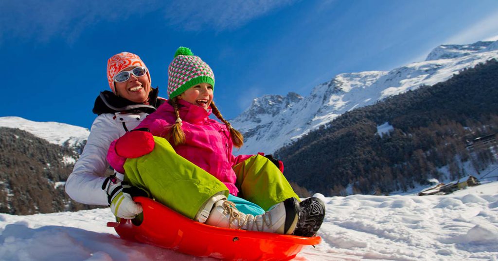 mom and daughter sledding in the Great Smokey Mountains