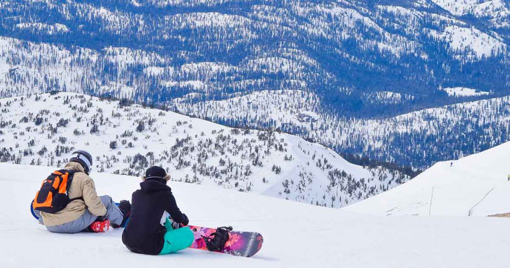 two snowboarders at the top of Mammoth Mountain