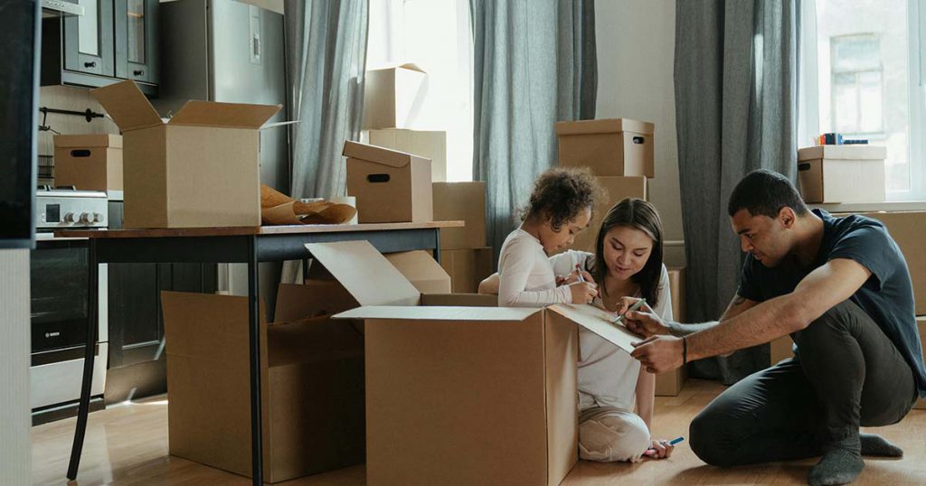 family packing up boxes to move