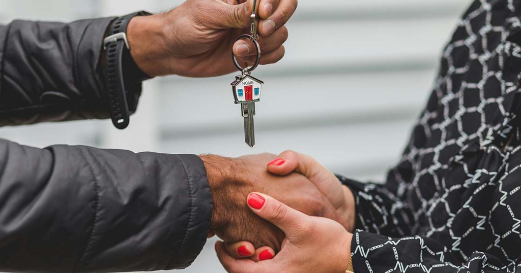 man getting a key to his house