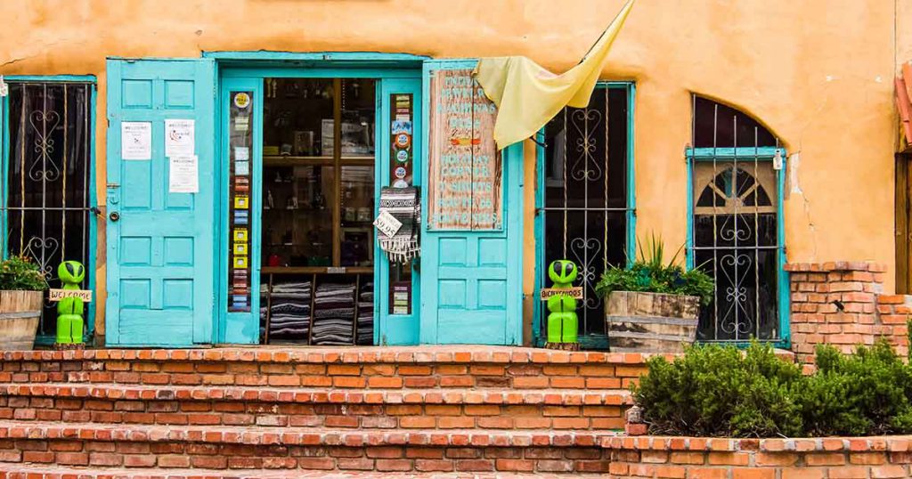 a shop with turquoise doors 