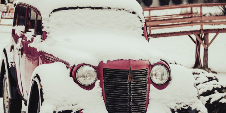 Vintage car covered in snow