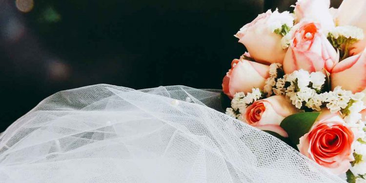 Floral wedding bouquet and white veil