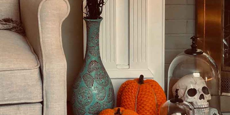 Pumpkins and fake skeletons on fireplace mantle