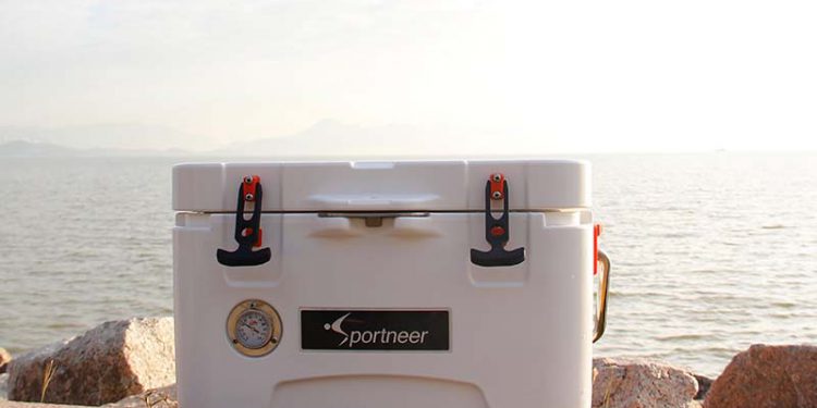 Cooler sitting on ground next to beach