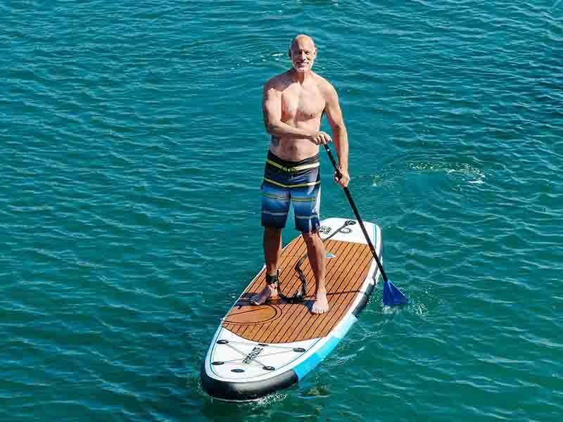 Man on paddle board in green water