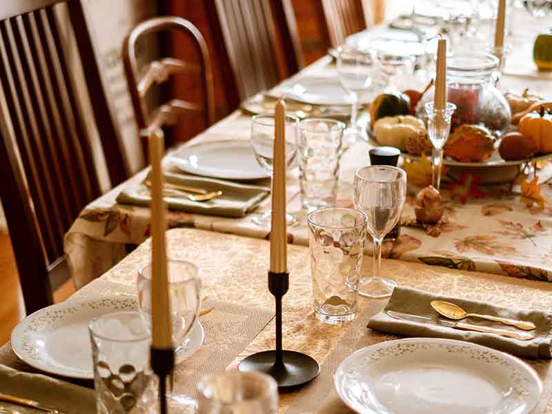 Table decorated with candlesticks and pumpkins