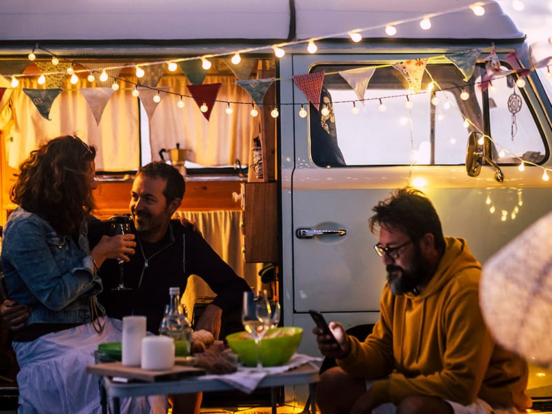 people enjoying a meal outside their van