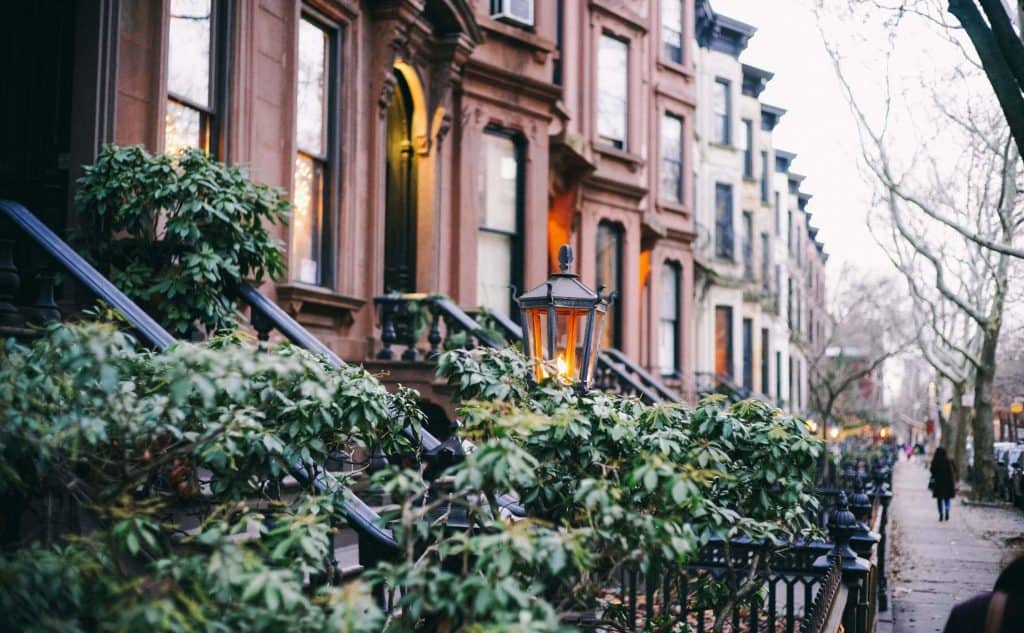 close up view of brownstone homes with a light out front