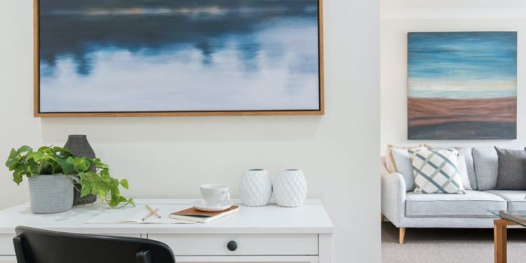 Blue canvas painting hanging in living room