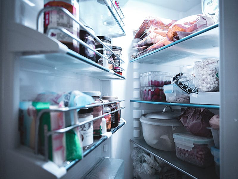 side view of open refrigerator door shelf