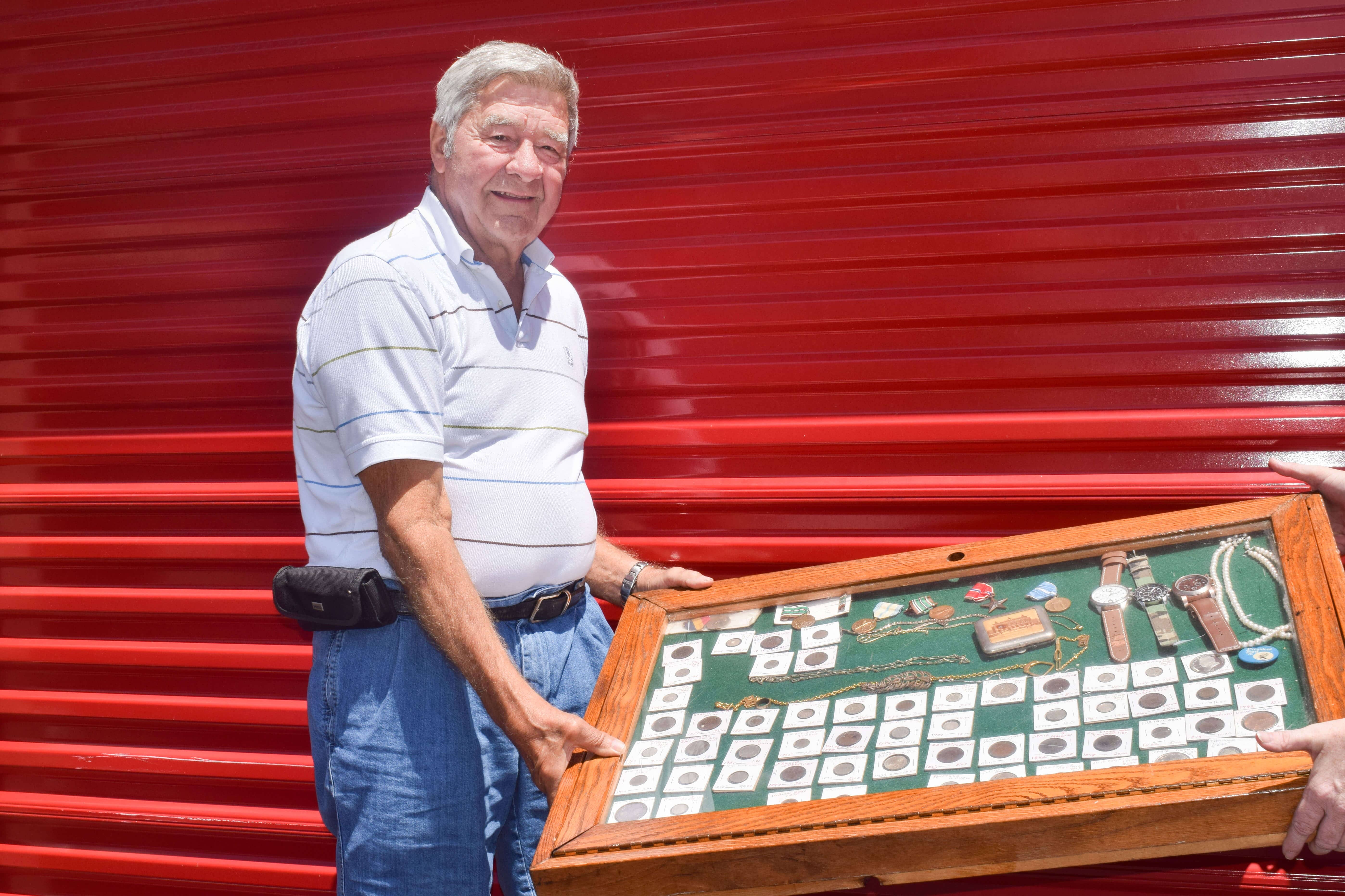 Richard Coyle holding an item from his storage unit
