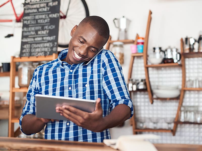 black man on computer in retail shop
