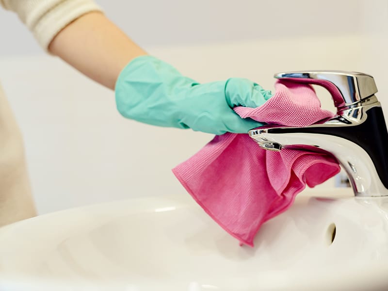 wiping bathroom faucet