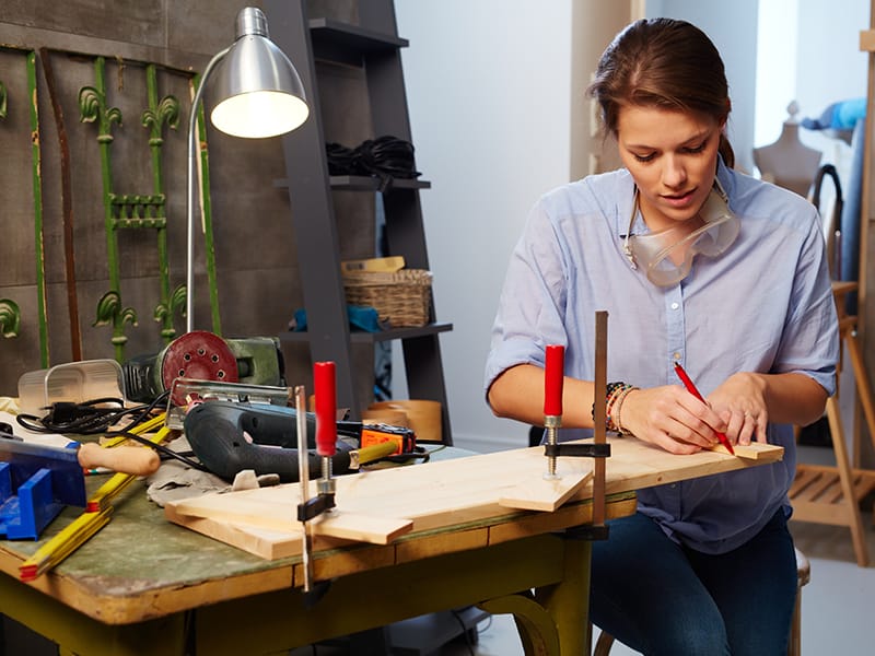 woman measuring with vice grips