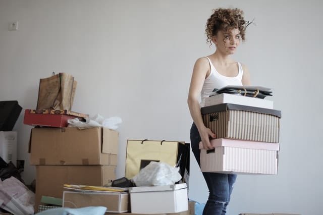 annoyed woman carrying boxes