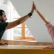 Couple high fiving over cardboard box