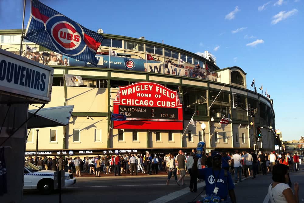 Iconic Wrigley Field sign with Cubs flag in the foreground